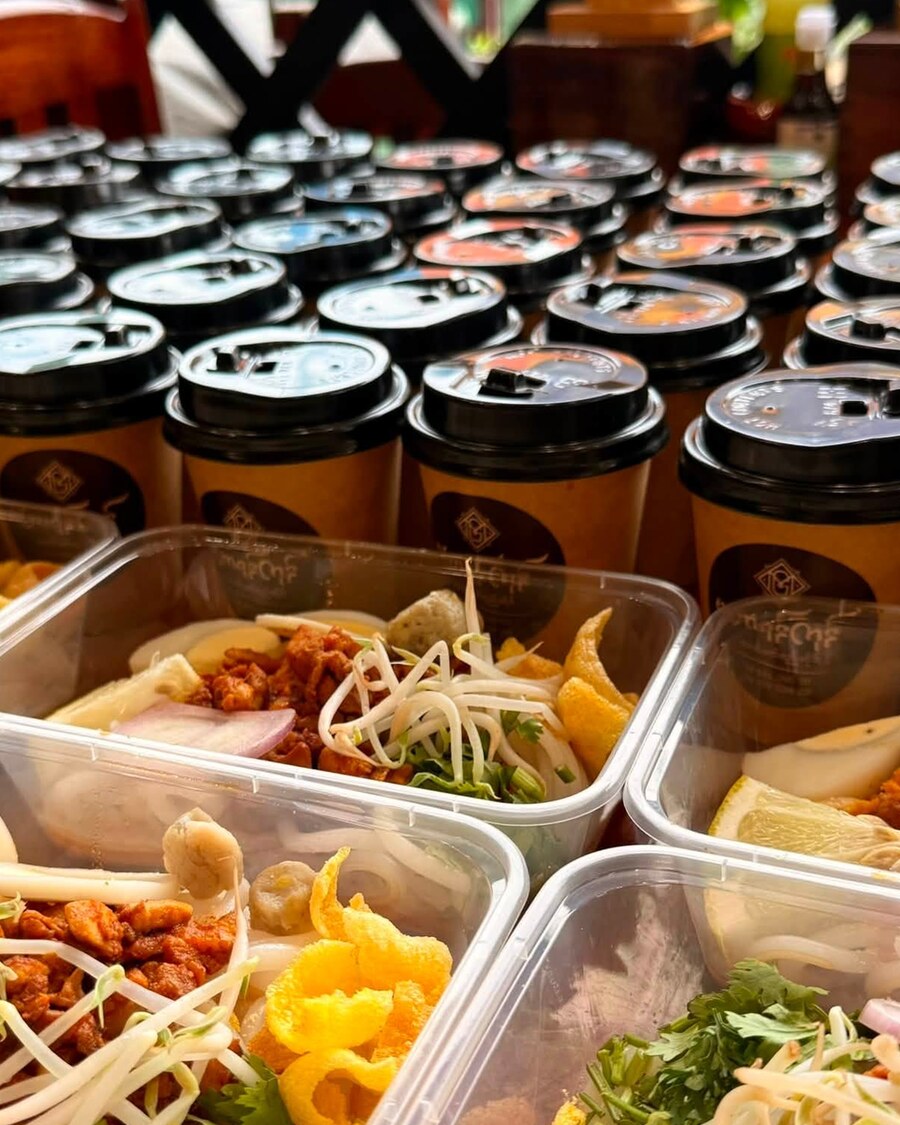 Rows of branded Mahar Yangon cups of laphet yay, lidded and ready to go